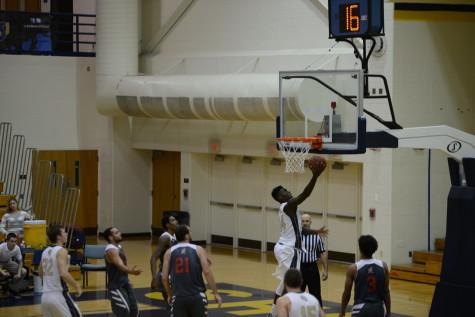 Winston Burgess, a Shepherd University men's basketball player, goes up and under or a layup during a game against the Davis and Elkins College Senators.
