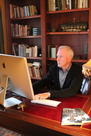 Gibson sits at the desk in his home study where he wrote his recently released novel, The Dead of Winter. 
