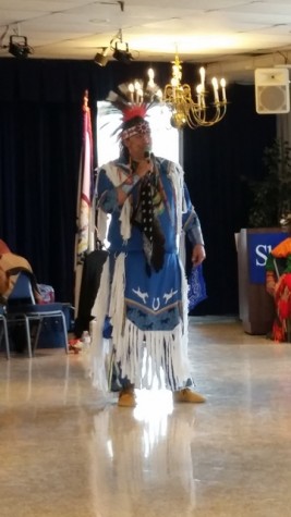 Arena Director Reed Brow, in full Lakota regalia, thanks the audience for their respect and participation during the event. 