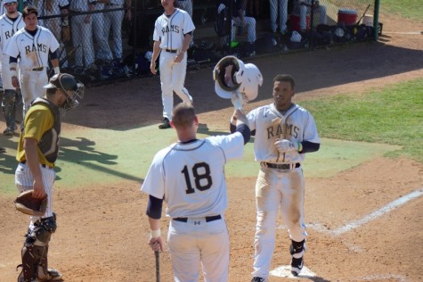 Tre Porter celebrates with #18 Christian Hamel after a home run against West Virginia State 