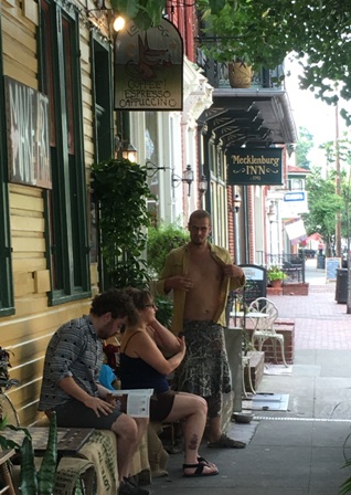 hree Shepherdstown residents enjoy the warm weather after getting coffee from The Lost Dog.