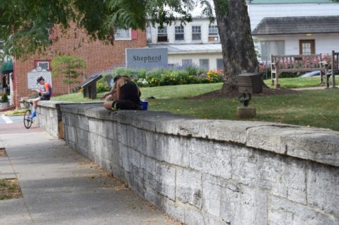 Shepherdstown residents soak up the last few days of summer by relaxing on the wall.