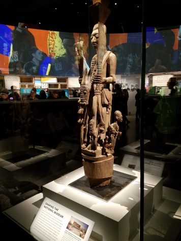A wooden stature in a traditional African style sits at the center for the first room in the hall dedicated to African American culture.